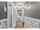 Decorated hallway with unique wallpaper, and accent lighting creating an inviting transition space at 433 San Salvador Dr, Dunedin, FL 34698