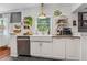 Bright kitchen featuring white cabinets, a farmhouse sink, stylish decor, and natural light from the window at 433 San Salvador Dr, Dunedin, FL 34698