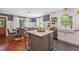 Charming kitchen with a farmhouse sink, open shelving, and a view into the adjacent dining area at 433 San Salvador Dr, Dunedin, FL 34698