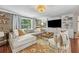 Comfortable living room with a large sectional sofa, decorative rug, and built-in shelving offering a relaxing space at 433 San Salvador Dr, Dunedin, FL 34698