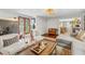 Spacious living room with hardwood floors, stylish decor, and ample seating providing an inviting atmosphere at 433 San Salvador Dr, Dunedin, FL 34698