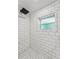 Modern tiled shower with a rainfall showerhead, clean design, and bright lighting providing a luxurious bathing space at 433 San Salvador Dr, Dunedin, FL 34698