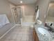 Well-lit bathroom with shower, tub, toilet, and single sink vanity with granite countertops at 4633 White Bay Cir, Wesley Chapel, FL 33545