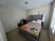 Bedroom with carpet flooring, full bed, and a bedside table at 4633 White Bay Cir, Wesley Chapel, FL 33545