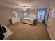 Spacious carpeted bedroom with white furniture set including a bed, dresser, and nightstands at 4633 White Bay Cir, Wesley Chapel, FL 33545
