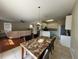 Bright dining and living area with a modern table, chairs, and access to kitchen at 4633 White Bay Cir, Wesley Chapel, FL 33545