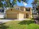 Two-story home featuring an attached two-car garage and a well-maintained front lawn at 4633 White Bay Cir, Wesley Chapel, FL 33545