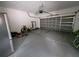 Functional garage with an automatic door, storage space, and gray painted floors at 4633 White Bay Cir, Wesley Chapel, FL 33545