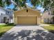 A large garage door is the focal point, flanked by exterior lights and an ample driveway at 4633 White Bay Cir, Wesley Chapel, FL 33545