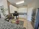 Well-equipped kitchen featuring white cabinets, stainless appliances, and granite countertops at 4633 White Bay Cir, Wesley Chapel, FL 33545