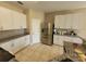 Well-lit kitchen with stainless steel refrigerator, granite countertops, and white cabinets at 4633 White Bay Cir, Wesley Chapel, FL 33545