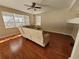 Bright living room with hardwood floors and a comfortable sectional sofa at 4633 White Bay Cir, Wesley Chapel, FL 33545
