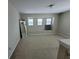 Well-lit loft area featuring neutral carpet, multiple windows, and stairway access at 4633 White Bay Cir, Wesley Chapel, FL 33545