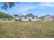 View of the expansive backyard showing the back of the house and ample space for various outdoor activities at 4707 Alma St, New Port Richey, FL 34652