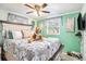 Cozy bedroom featuring a bed, ceiling fan, and soft, colorful decor at 4707 Alma St, New Port Richey, FL 34652