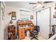 Bedroom with a desk, ceiling fan, and lots of decorations at 4707 Alma St, New Port Richey, FL 34652