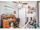 Bedroom with a desk, ceiling fan, and lots of decorations at 4707 Alma St, New Port Richey, FL 34652