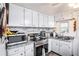 Efficient kitchen featuring ample counter space, modern appliances, and stylish backsplash for a delightful cooking experience at 4707 Alma St, New Port Richey, FL 34652