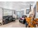 Comfortable living room featuring reclining seating, stylish decor, and sliding glass doors to the backyard at 4707 Alma St, New Port Richey, FL 34652
