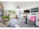 Enclosed sunroom patio area with seating, plants, and a ceiling fan at 4707 Alma St, New Port Richey, FL 34652