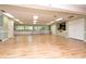 Activity room featuring hardwood flooring, large windows, and plenty of tables for crafts or socializing at 4997 Bostonian Loop # 4997, New Port Richey, FL 34655