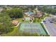 Overhead shot of the tennis courts, community pool, clubhouse, and parking lot at 4997 Bostonian Loop, New Port Richey, FL 34655