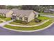 Aerial view of a single-story home with a lawn and landscaping in a well-maintained community at 4997 Bostonian Loop # 4997, New Port Richey, FL 34655
