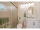 Well-lit bathroom featuring a glass-enclosed shower and white vanity at 4997 Bostonian Loop, New Port Richey, FL 34655