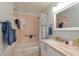 Well-lit bathroom featuring a shower and vanity with white cabinets at 4997 Bostonian Loop, New Port Richey, FL 34655