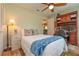 This bedroom features a ceiling fan, and a built-in desk at 4997 Bostonian Loop, New Port Richey, FL 34655