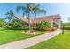 Landscaped community clubhouse with lush greenery, palm trees, and well-maintained walkway at 4997 Bostonian Loop # 4997, New Port Richey, FL 34655