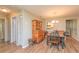Cozy dining area with wood table, chairs, and a view into kitchen at 4997 Bostonian Loop # 4997, New Port Richey, FL 34655