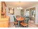 Charming dining area with wood table and seating, and natural light at 4997 Bostonian Loop, New Port Richey, FL 34655