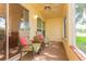 Enclosed lanai with comfortable seating and a ceiling fan at 4997 Bostonian Loop, New Port Richey, FL 34655
