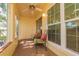 Enclosed lanai with comfortable seating and a ceiling fan at 4997 Bostonian Loop, New Port Richey, FL 34655