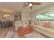 Comfortable living room with sofas, wood flooring, and an adjacent dining area at 4997 Bostonian Loop, New Port Richey, FL 34655