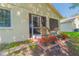 Rear patio with cozy seating and potted flowers at 4997 Bostonian Loop, New Port Richey, FL 34655