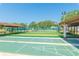 Enjoy the sunny shuffleboard courts featuring covered benches and nearby tennis courts for community recreation at 4997 Bostonian Loop, New Port Richey, FL 34655