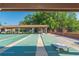 View of the shuffleboard courts with covered seating in a well-maintained community, perfect for active residents at 4997 Bostonian Loop # 4997, New Port Richey, FL 34655