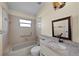 Bathroom featuring a combination tub and shower, granite countertops, and stylish fixtures at 5290 White Sand Ne Cir, St Petersburg, FL 33703