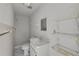 A full white bathroom with a shower, toilet, sink, vanity and wire shelving at 5290 White Sand Ne Cir, St Petersburg, FL 33703