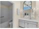 Bathroom with a wide mirror, vanity, and garden view window at 5290 White Sand Ne Cir, St Petersburg, FL 33703