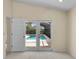 Bright bedroom featuring an outdoor view of the sparkling in-ground pool at 5290 White Sand Ne Cir, St Petersburg, FL 33703