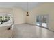 Bright open-concept dining room featuring a chandelier and sliding doors to the patio at 5290 White Sand Ne Cir, St Petersburg, FL 33703