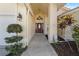 Charming front entrance with decorative lighting and mature landscaping creates inviting curb appeal at 5290 White Sand Ne Cir, St Petersburg, FL 33703