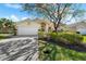 Charming single-story home boasts lush landscaping, mature trees, and a well-maintained two-car garage and inviting entrance at 5290 White Sand Ne Cir, St Petersburg, FL 33703