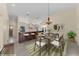 Open-concept kitchen and dining area featuring a large island, modern appliances, and stylish chandelier at 5290 White Sand Ne Cir, St Petersburg, FL 33703