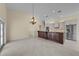 Open-concept area with a kitchen featuring modern appliances, a large island, and seamless flow to the adjoining spaces at 5290 White Sand Ne Cir, St Petersburg, FL 33703