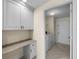 Laundry room with a built-in counter and cabinets, and a separate closet at 5290 White Sand Ne Cir, St Petersburg, FL 33703