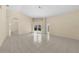 Spacious living room with tile flooring, neutral walls, and a view of the screened-in pool through sliding glass doors at 5290 White Sand Ne Cir, St Petersburg, FL 33703